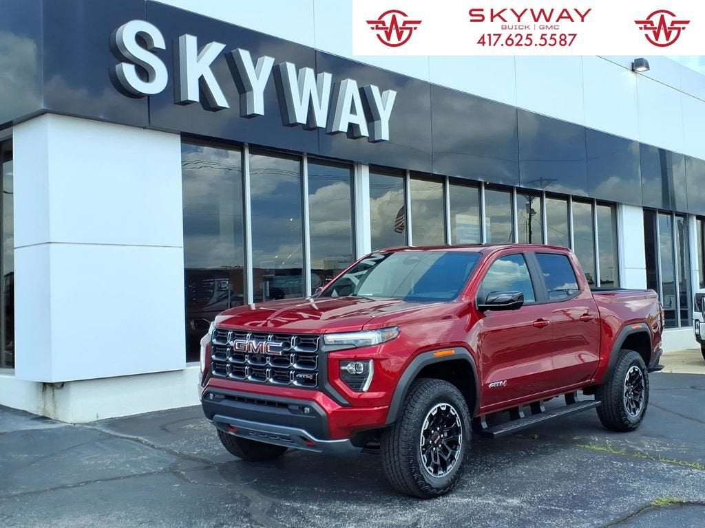 2026 GMC Canyon AT4 in Volcanic Red Tintcoat — front three-quarter view