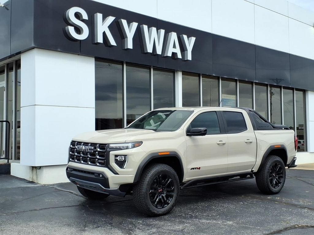 2026 GMC Canyon AT4 in Coastal Dune — front three-quarter view